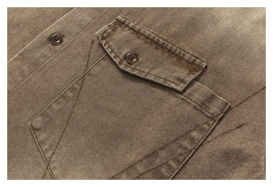 Close-up of a brown washed shirt's buttoned chest pocket and stitching.