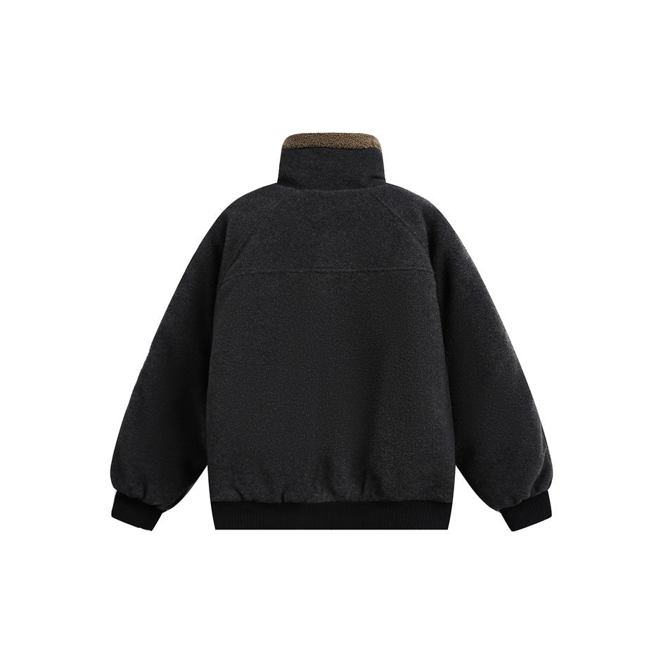 Back view of a charcoal jacket with a tall collar, tan trim at the top, and black ribbed cuffs and hem.