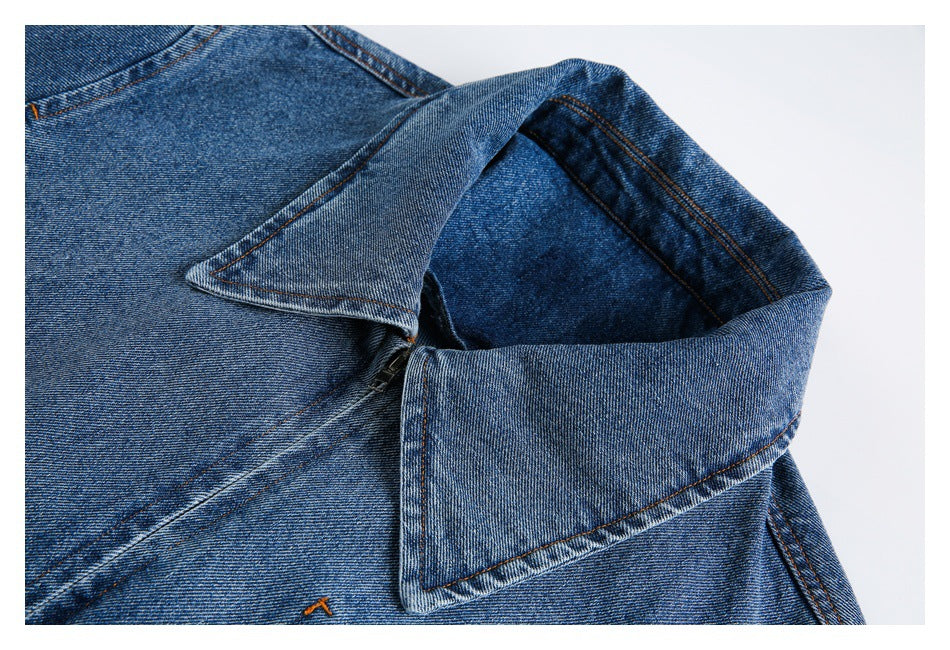 Close-up of the blue denim jacket's wide collar, shoulder seam and stitching.