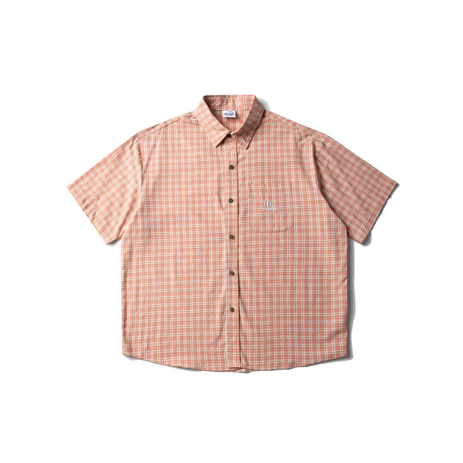 Front view of a peach plaid short-sleeve button-up shirt with a pointed collar, chest pocket, and small embroidery.