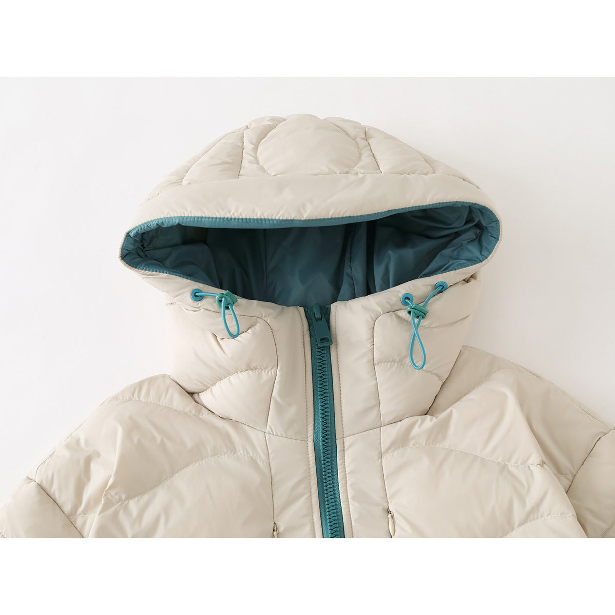 Close-up of an ivory quilted jacket hood with teal lining, drawcords, and a teal front zipper.