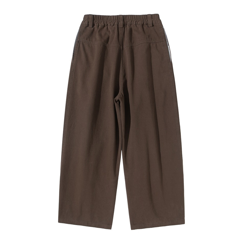 Back view of coffee brown wide-leg pants with elastic waistband, back yoke seam and side pocket openings