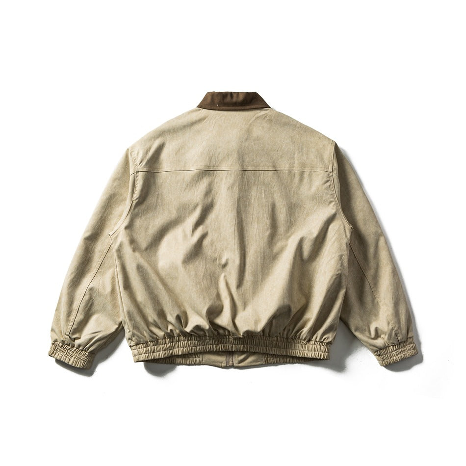 Back view of a light beige collared jacket with elastic cuffs and gathered hem.