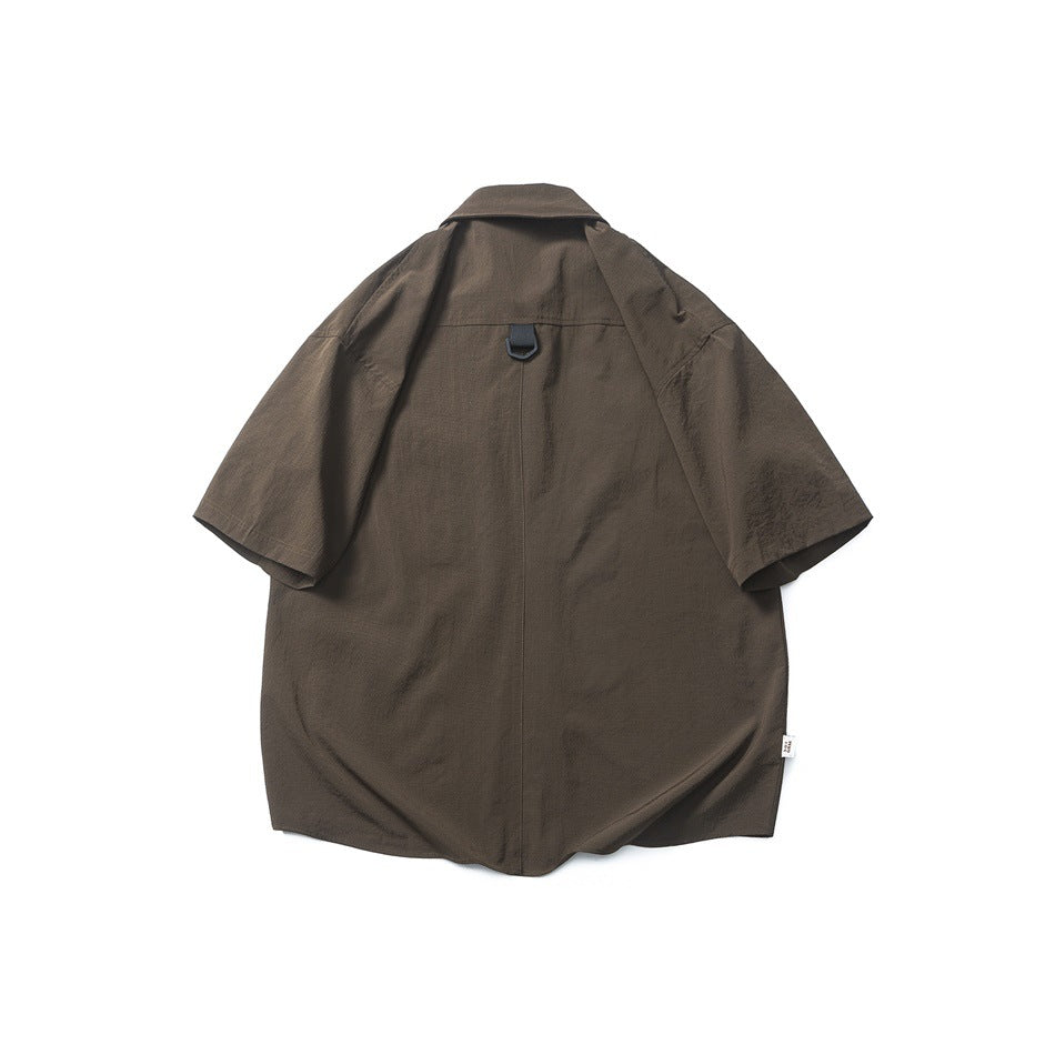 Back view of brown short-sleeve shirt with center seam and black D-ring loop at the upper back