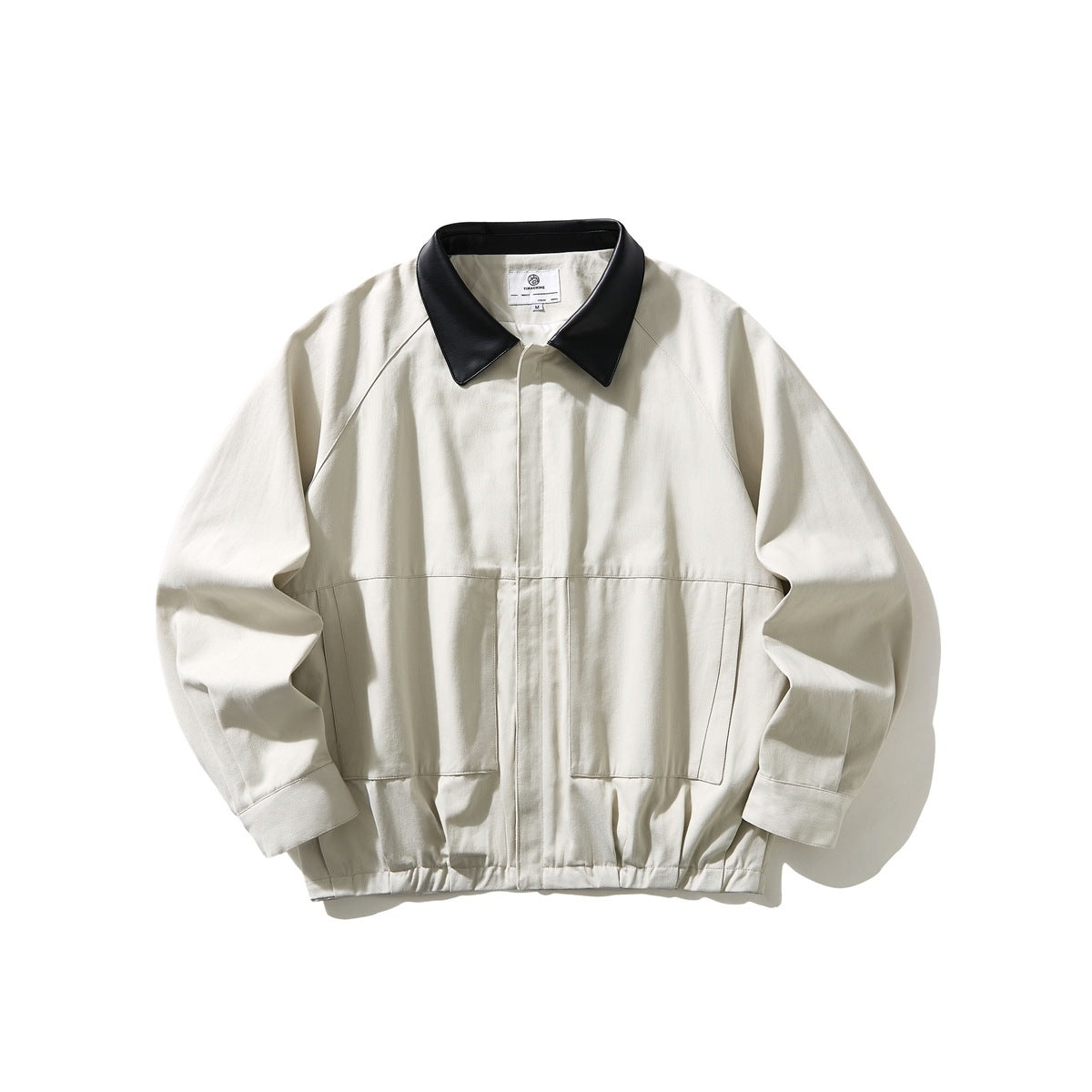 Off-white jacket with black leather-look collar, raglan sleeves, front pockets and gathered hem, flat lay