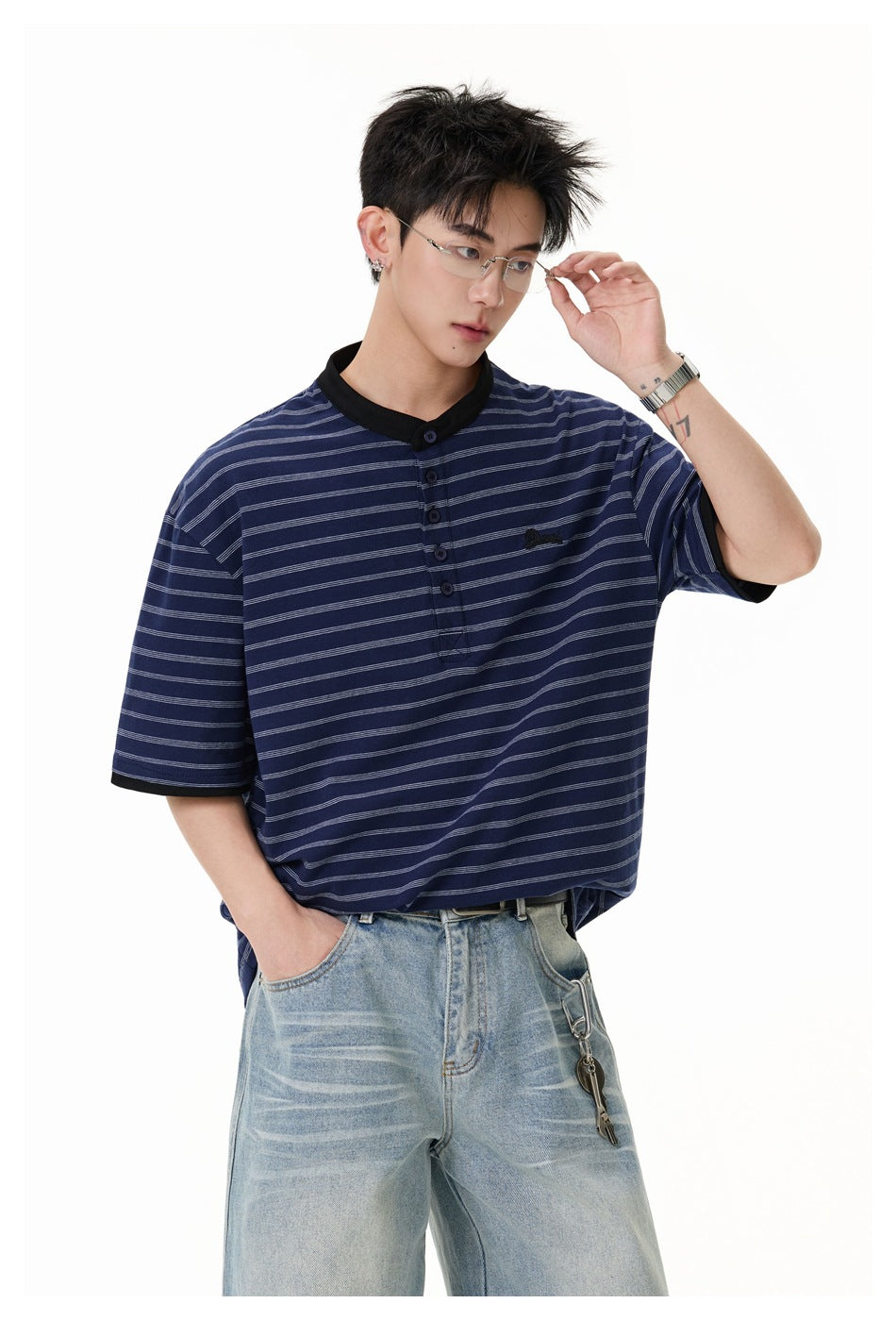 Close view of a model wearing a navy striped henley with black trim and a button placket.