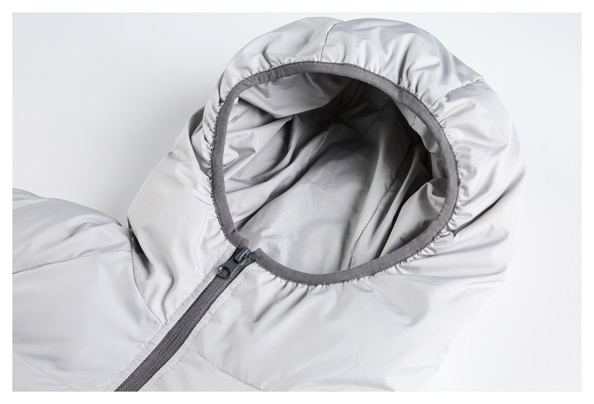 Close-up of the light gray quilted jacket's hood opening, dark trim, and front zipper.