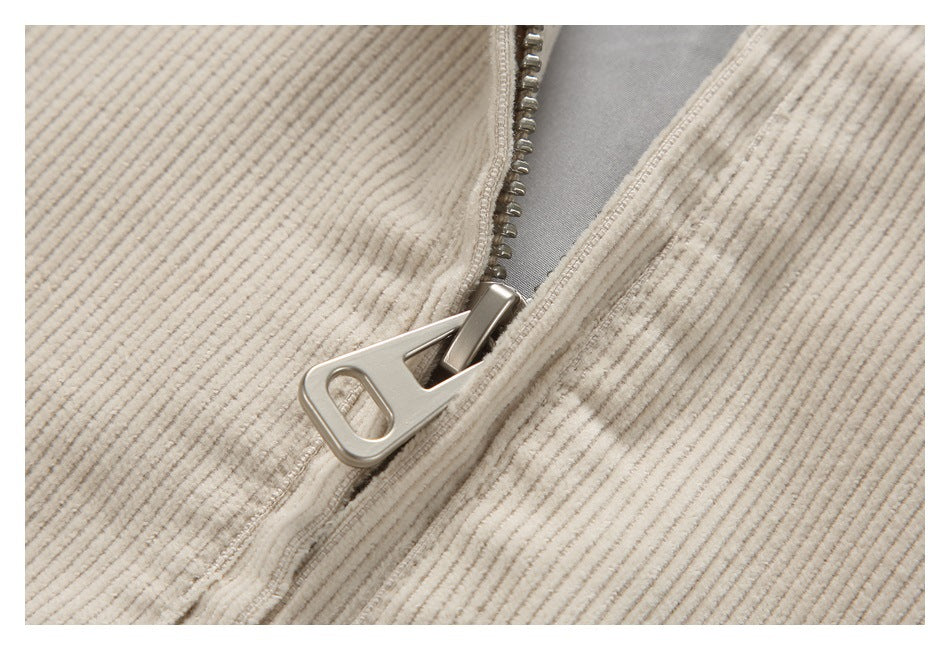 Close-up of the cream corduroy jacket's metal zipper and pull.