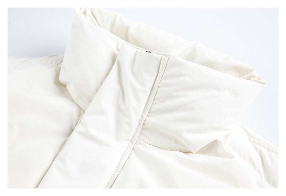 Close-up of the folded collar and stitched seams on an ivory garment.