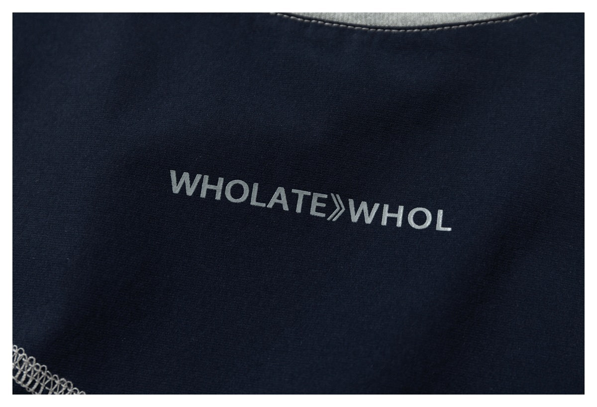 Close-up of white lettering printed on navy fabric, with gray overlock stitching visible along the edge.