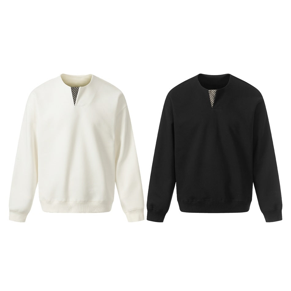 Ivory and black sweatshirts shown side by side, each with a small patterned insert at the neckline.