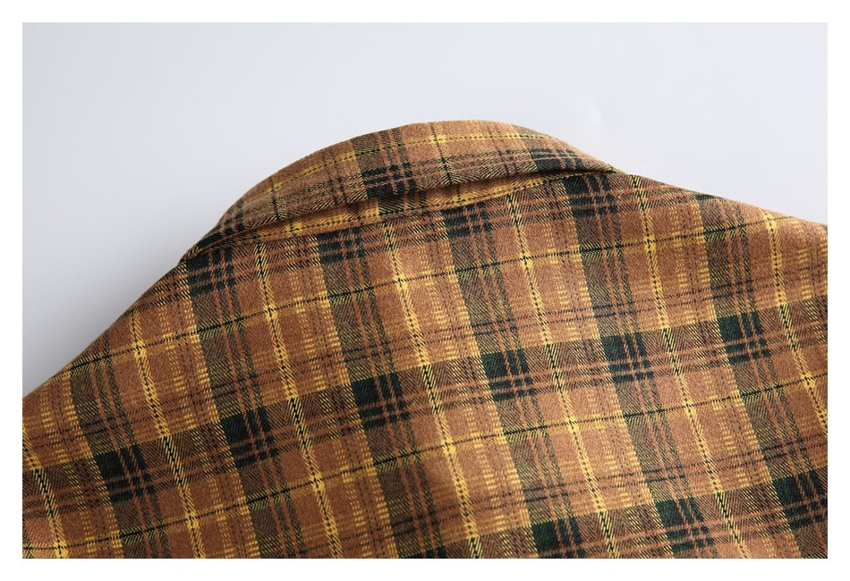 Close-up of the collar and upper back of a brown, mustard, and dark green plaid shirt.