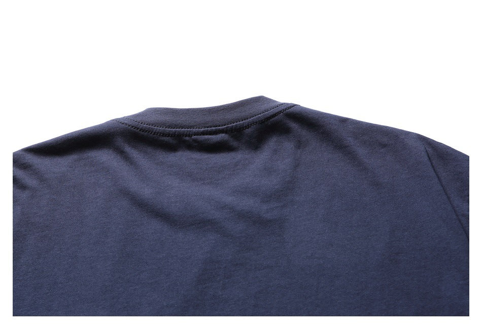 Close-up of the upper back of a plain navy shirt, showing the crew neckline and shoulder seams.