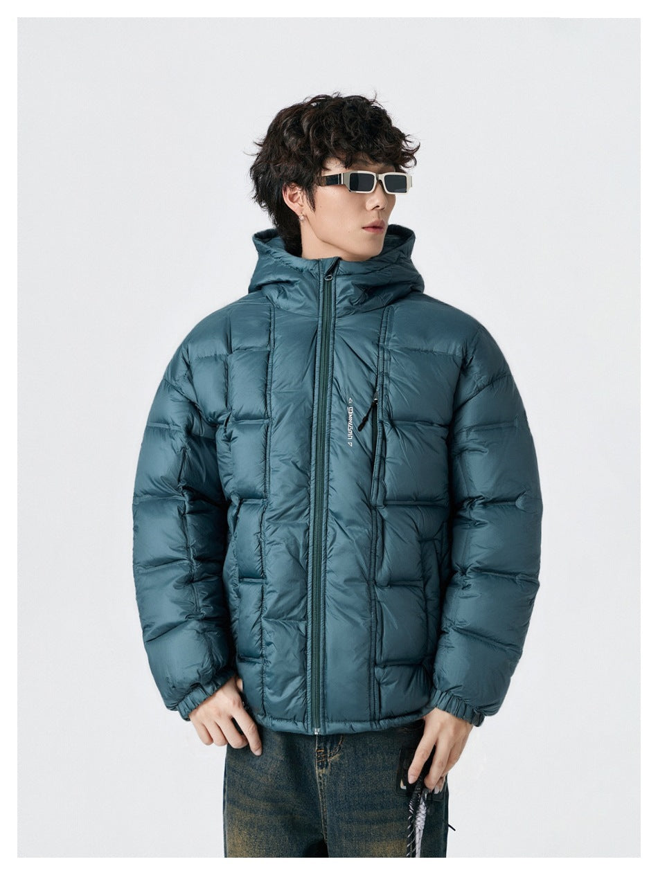 Model wearing a teal hooded puffer jacket zipped up, shown from the front.