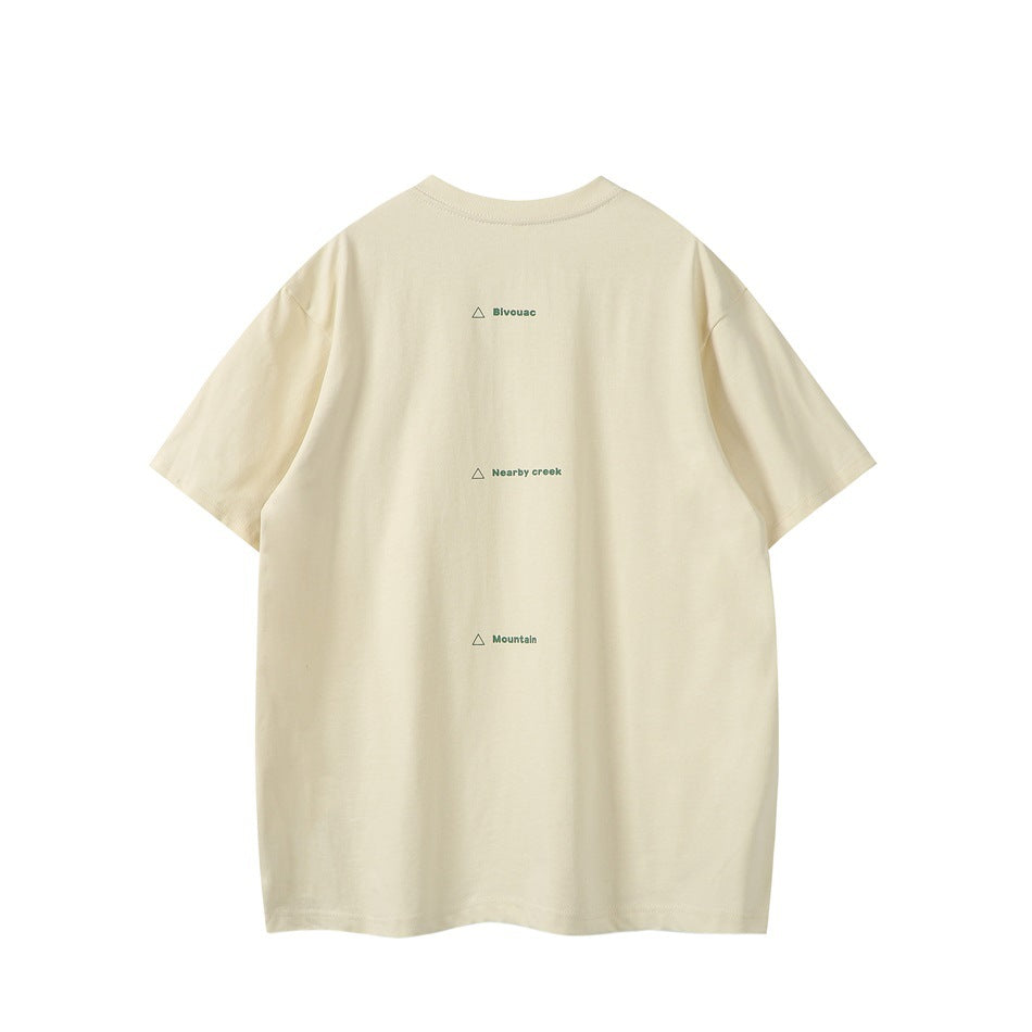 Back of apricot T-shirt with three small green triangle-marked text lines printed down the upper back