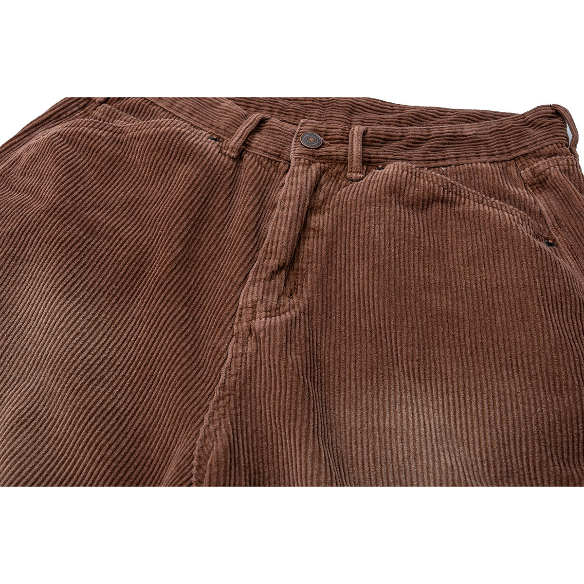 Close-up of brown corduroy shorts showing the waistband, button, belt loops and front pocket.
