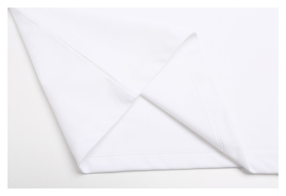 Close-up of the white T-shirt's seam and stitching at a folded edge.