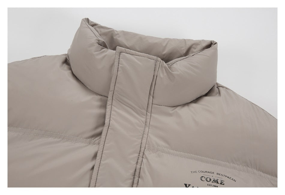 Close-up of the taupe jacket's padded stand collar and chest print.