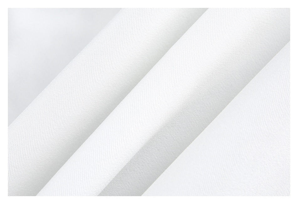 Close-up of folded white fabric showing its fine diagonal weave.