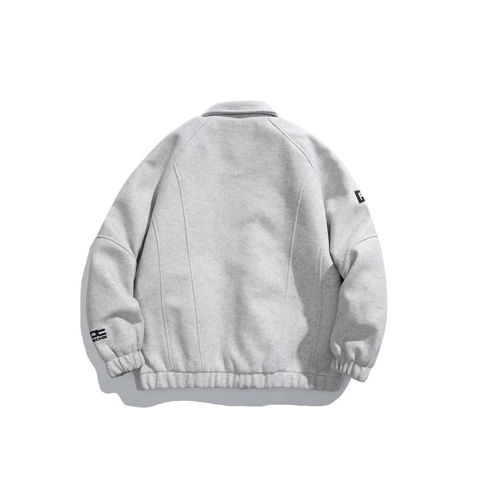 Back view of a light gray jacket with a fold-over collar, curved panel seams, elastic cuffs and hem, and small sleeve