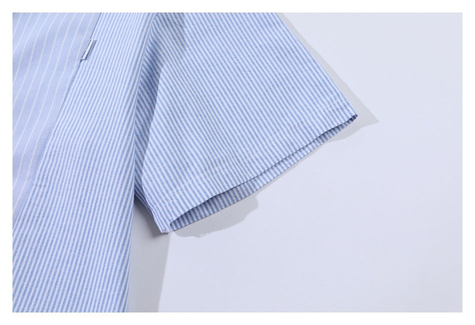 Close-up of a light blue garment sleeve with fine blue-and-white stripes and a narrow fabric tag.