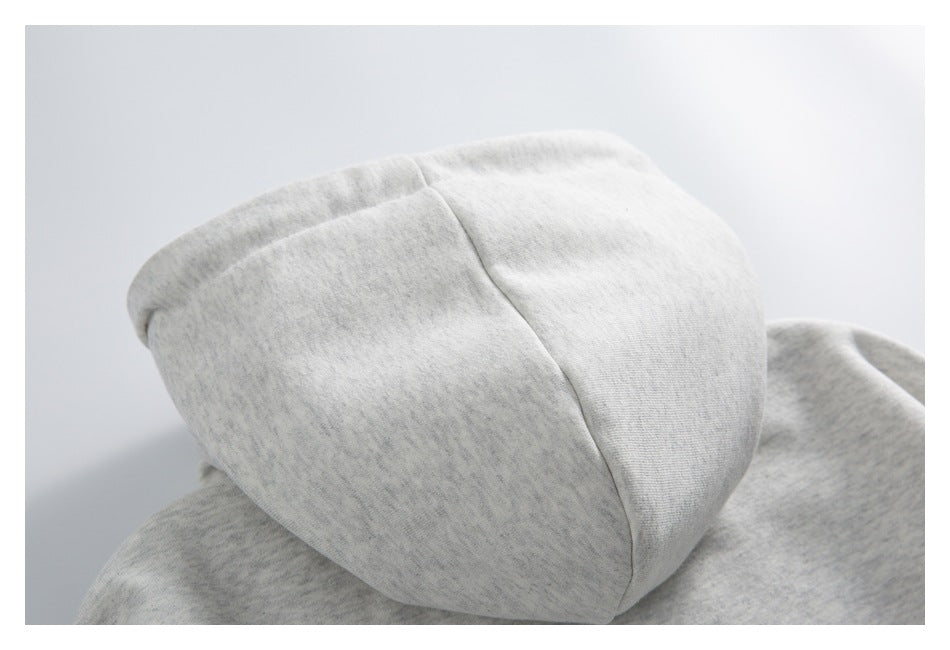 Close-up of the hood of a light heather-gray sweatshirt.