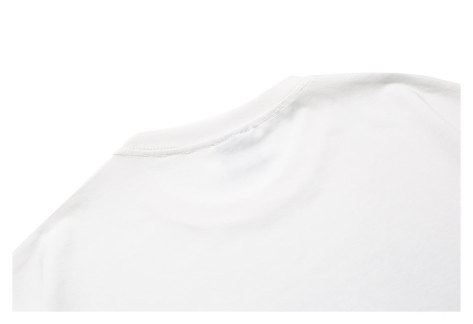 Close-up of the white T-shirt neckline and shoulder seam.