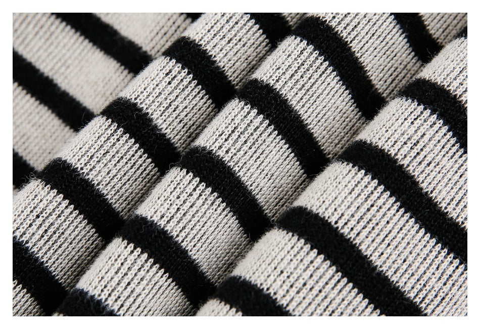 Close-up of black and light gray plaid knit fabric showing its ribbed texture.