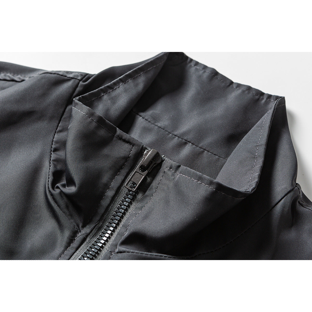 Close-up of a black jacket's stand collar and front zipper.