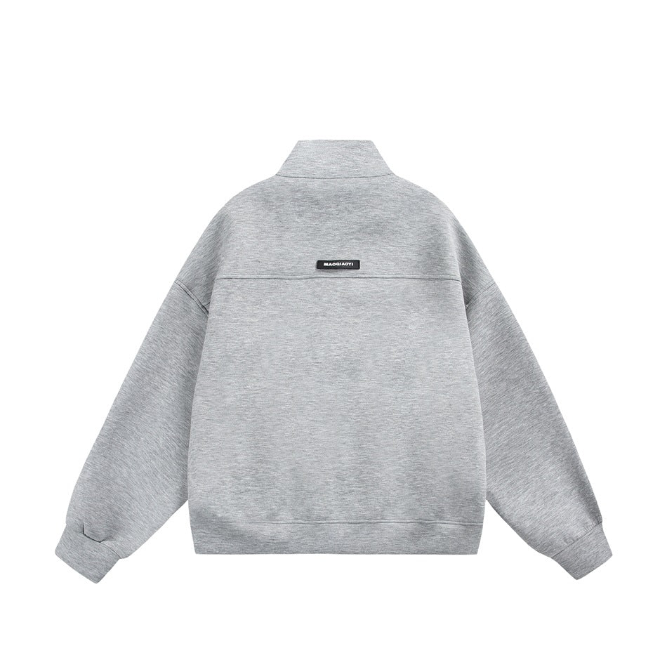 Light heather gray stand-collar jacket flat lay, back view with yoke seam and small label patch