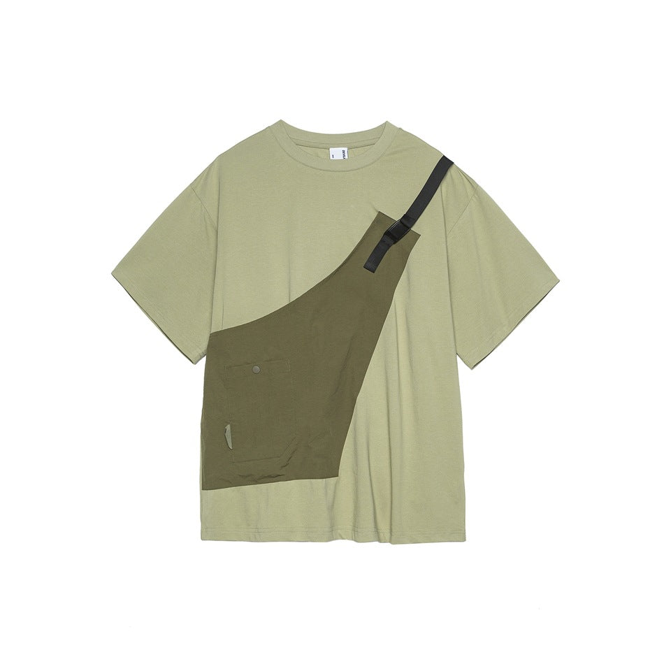 Light green short-sleeve T-shirt with an olive asymmetric sling-style panel, pocket and black strap, flat lay