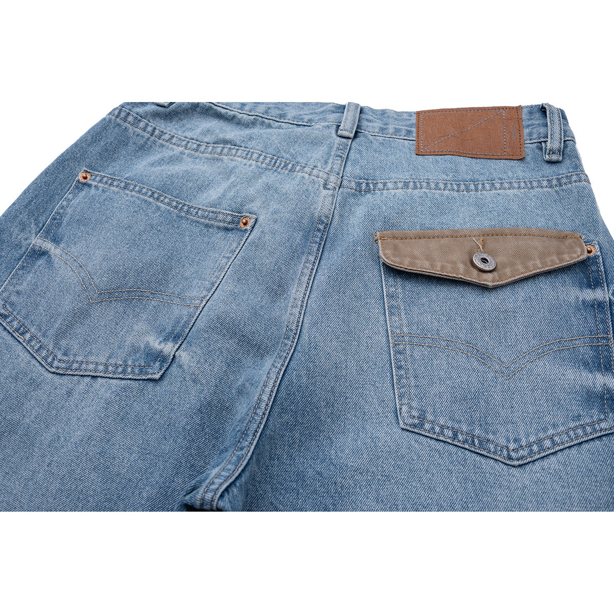 Close-up of the back of light blue jeans, showing two pockets, a buttoned flap, and a brown waistband patch.