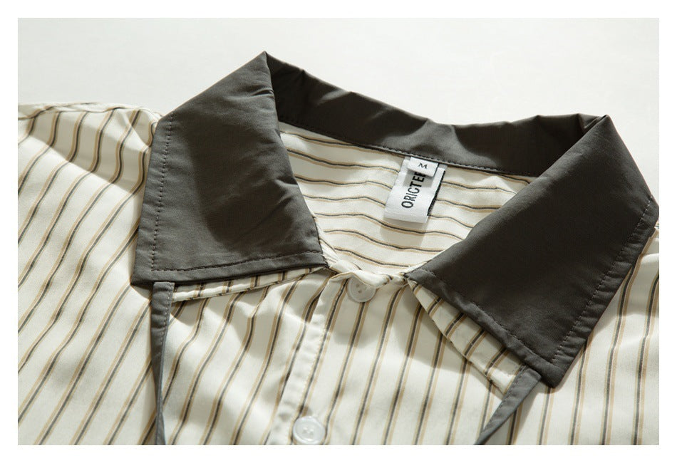 Close-up of a cream striped shirt collar with dark gray panels and a visible neck label.