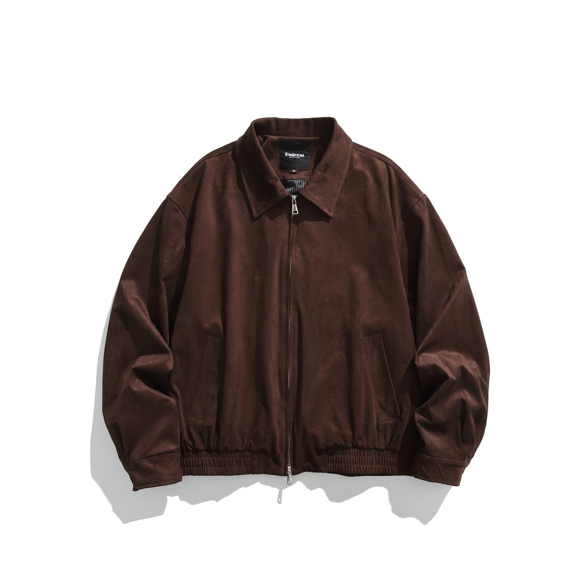 Brown suede-like collared zip-front jacket laid flat, front view with slanted pockets and elastic hem