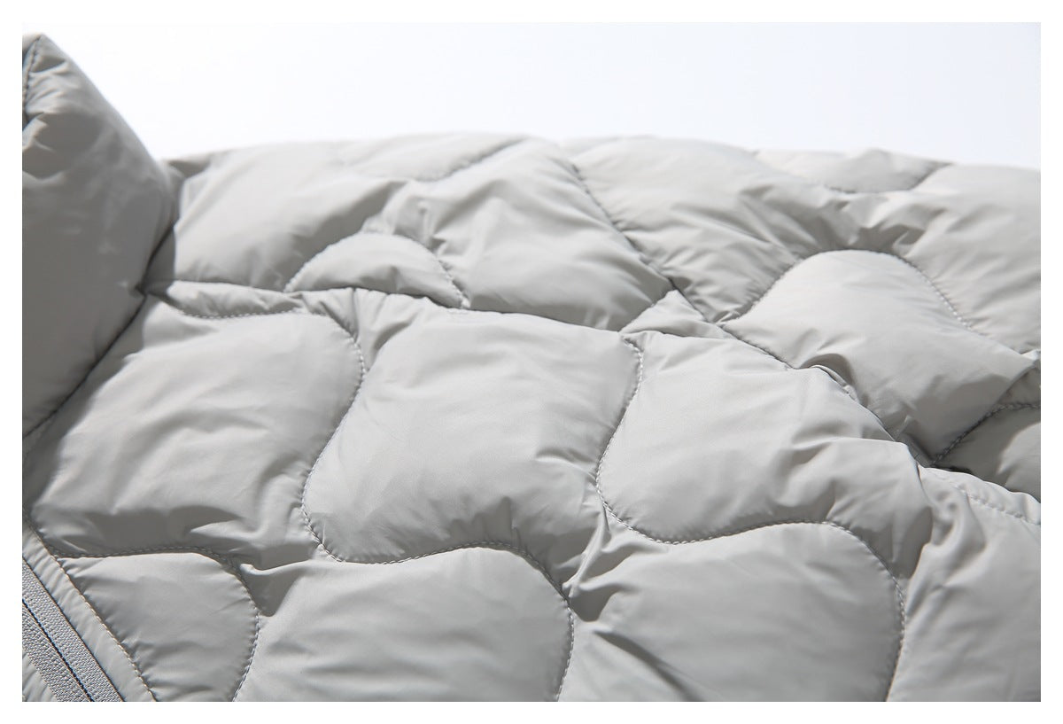 Close-up of the light gray jacket's stitched, wavy quilted padding.