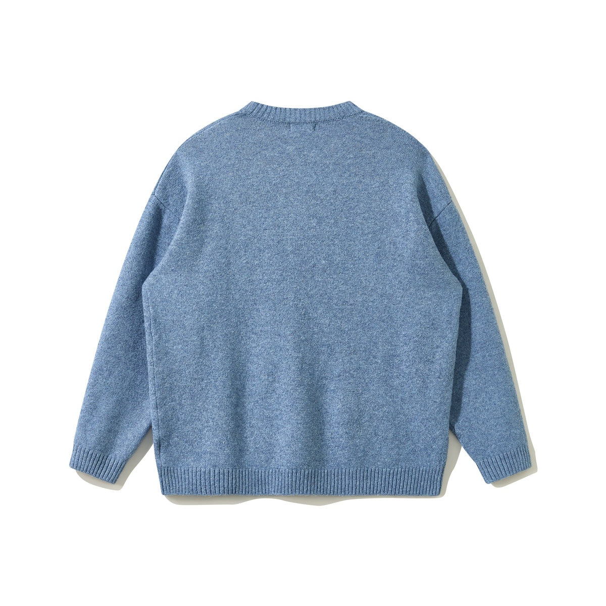 Blue crewneck knit sweater flat lay, back view, with dropped shoulders and ribbed hem
