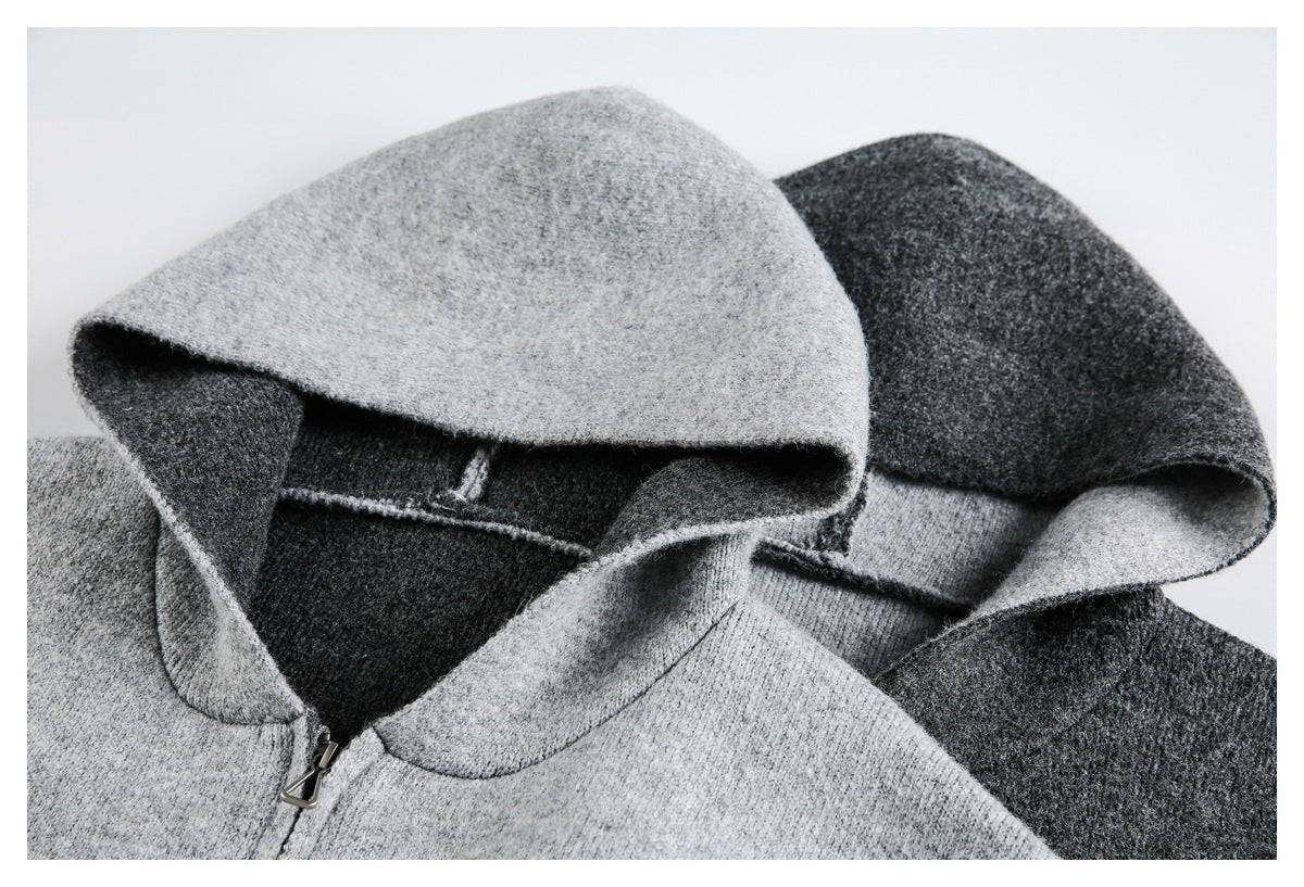 Close-up of light and charcoal gray jacket hoods, showing the inner construction and zipper pull.