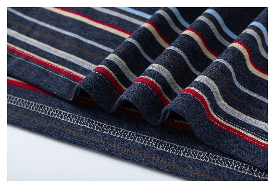 Close-up of the striped navy garment hem, showing multicolor stripes and an overlock seam.