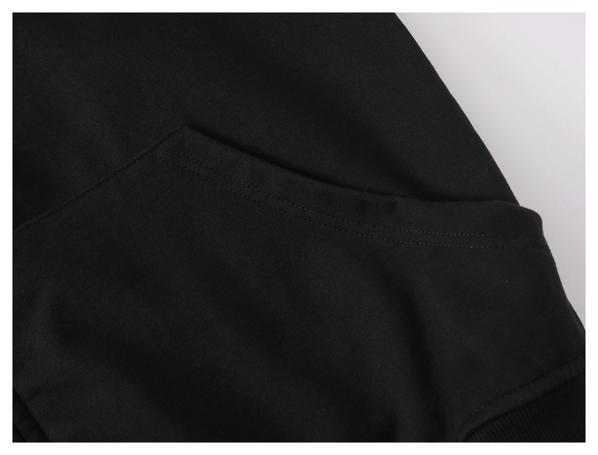 Close-up of black fabric with a stitched seam and ribbed edge.