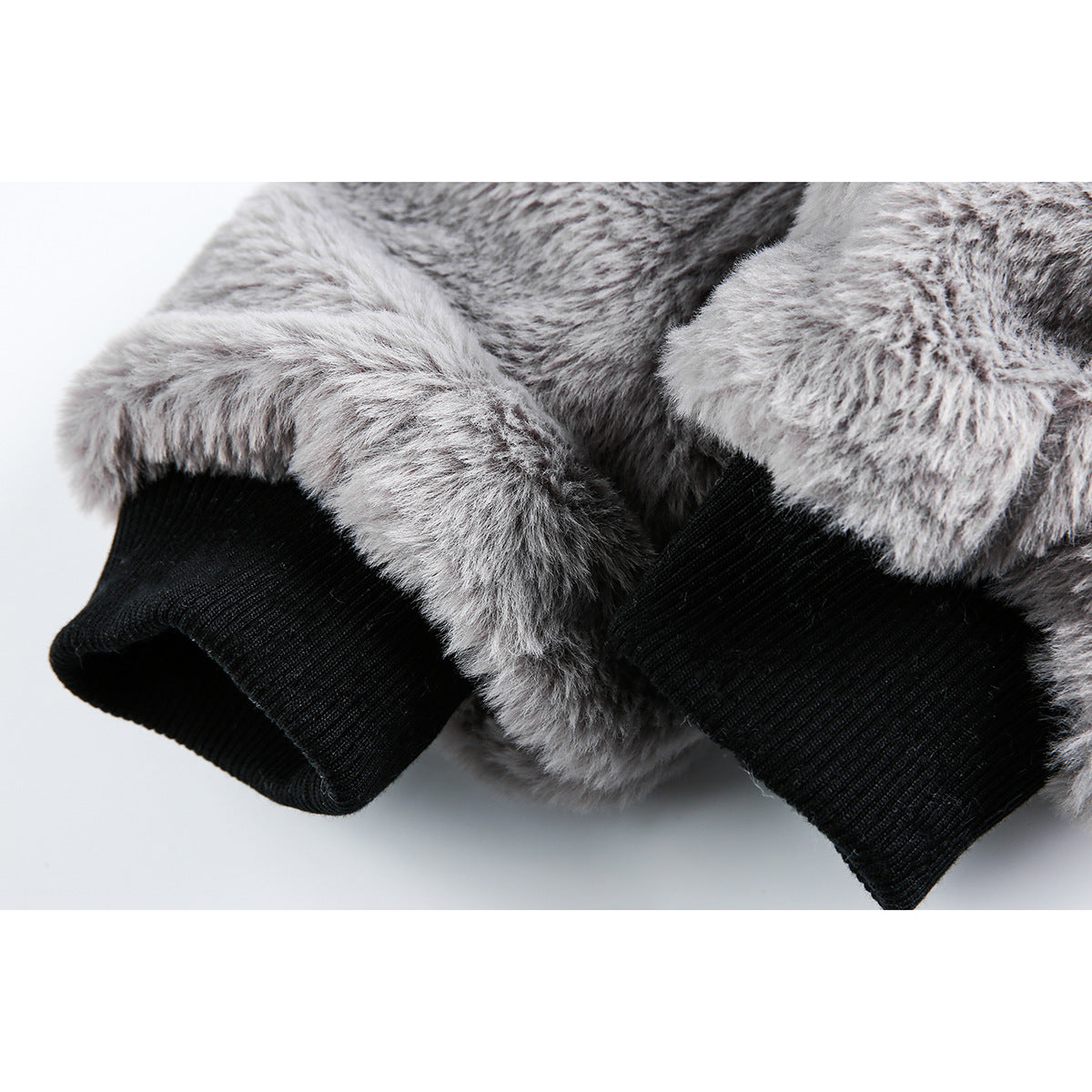 Close-up of the gray fuzzy jacket's sleeves and black ribbed cuffs.