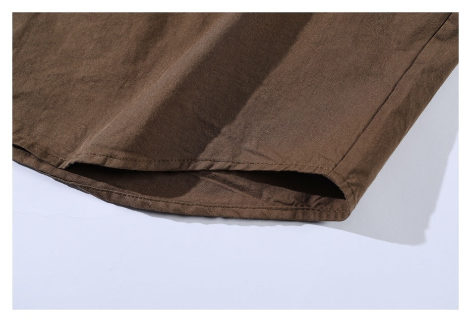 Close-up of the double-stitched hem on a brown shirt.