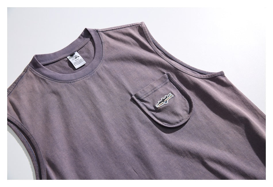 Close-up of the shirt front showing its crew neck, chest pocket and small embroidered patch.