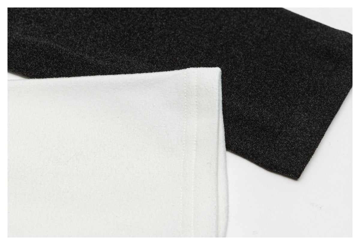 Close-up of white and charcoal fabric edges and a stitched seam.