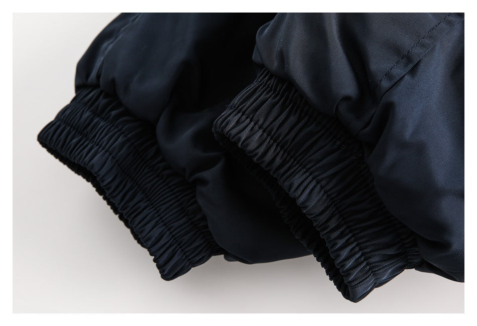 Close-up of dark navy garment cuffs with gathered elastic hems.
