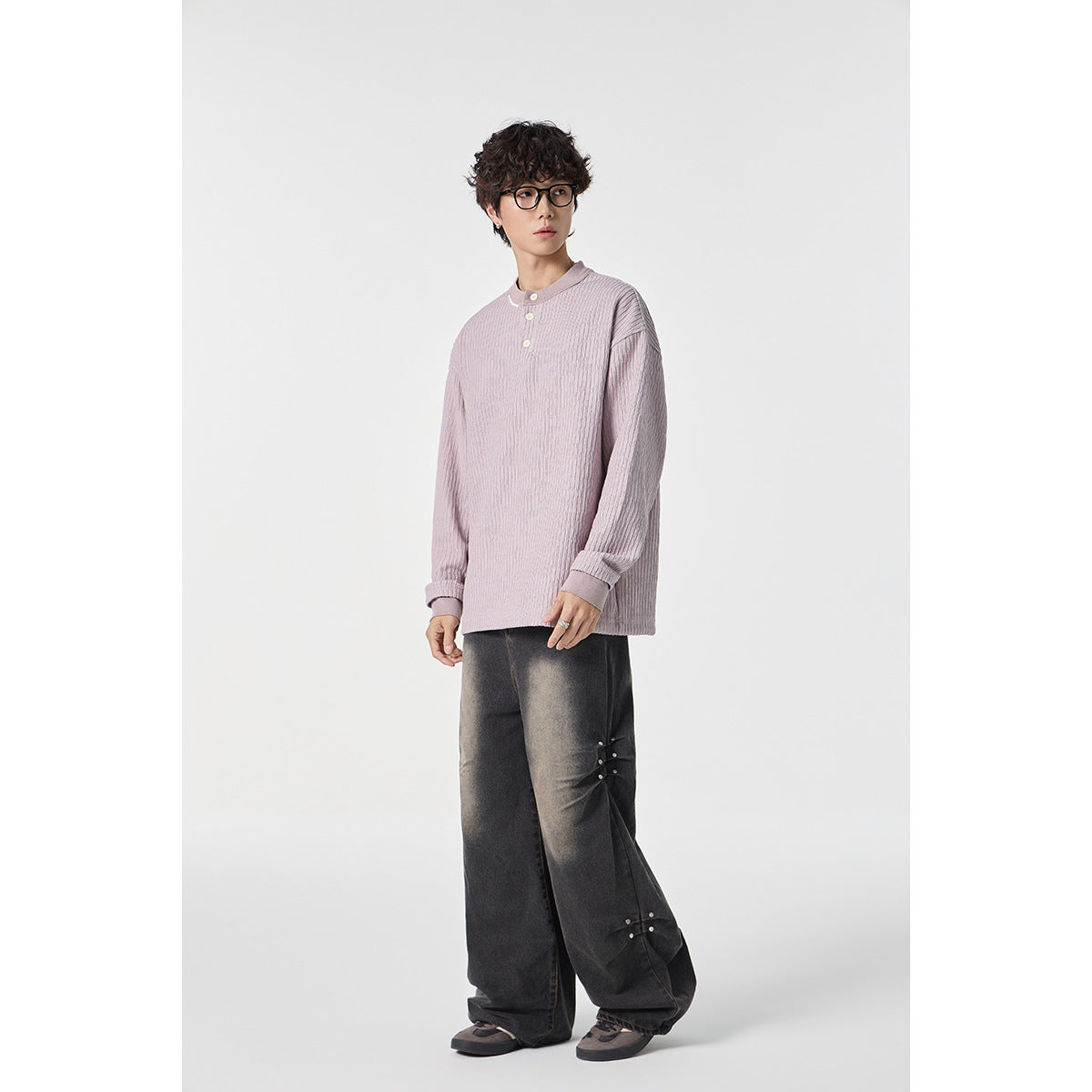 Model wearing a pale mauve ribbed Henley with oversized dark gray wide-leg trousers.