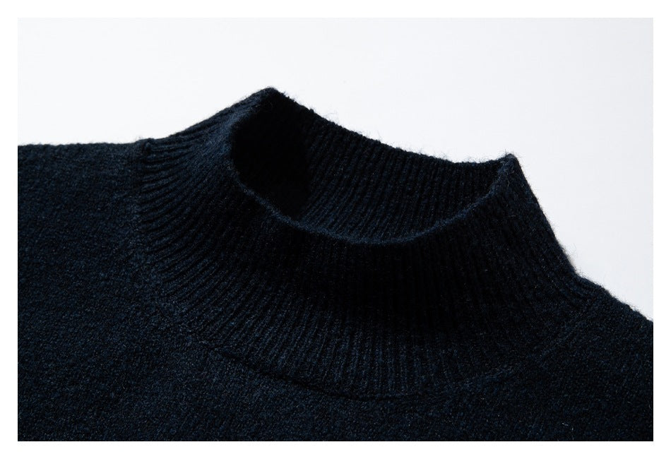 Close-up of the dark navy sweater’s ribbed high neckline and knit texture.