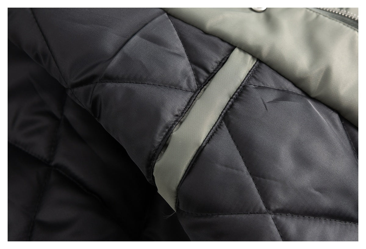 Close-up of the jacket’s dark quilted lining and an olive fabric loop.