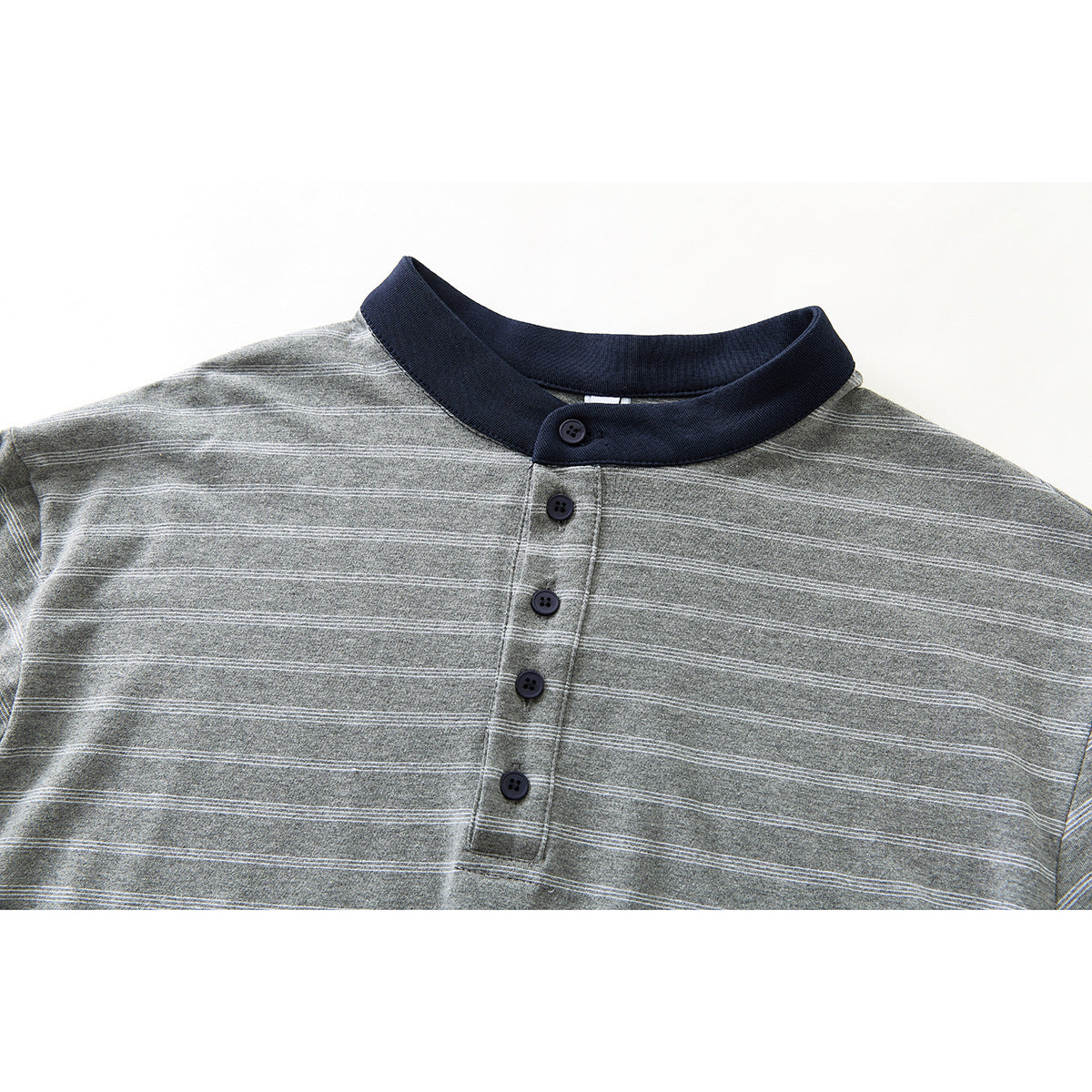 Close-up of a gray striped shirt with a navy stand collar and five-button placket.