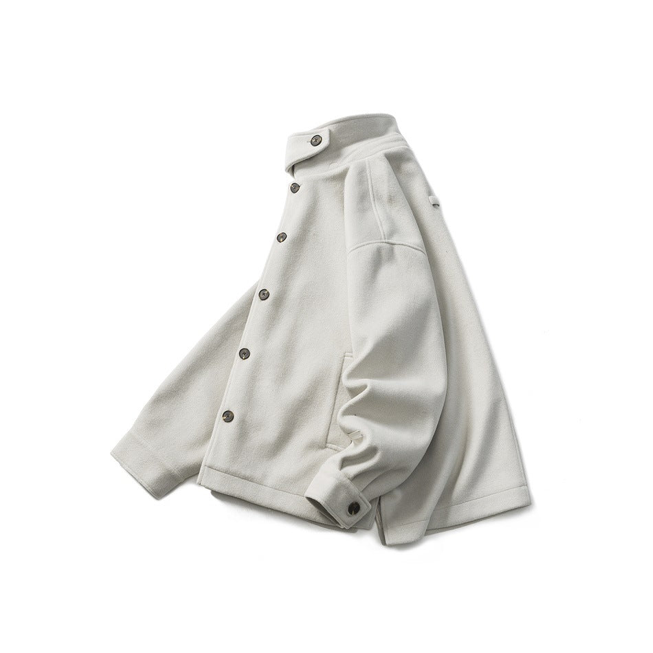 Ivory button-front coat with a high collar, long sleeves, and angled pockets, shown against white.