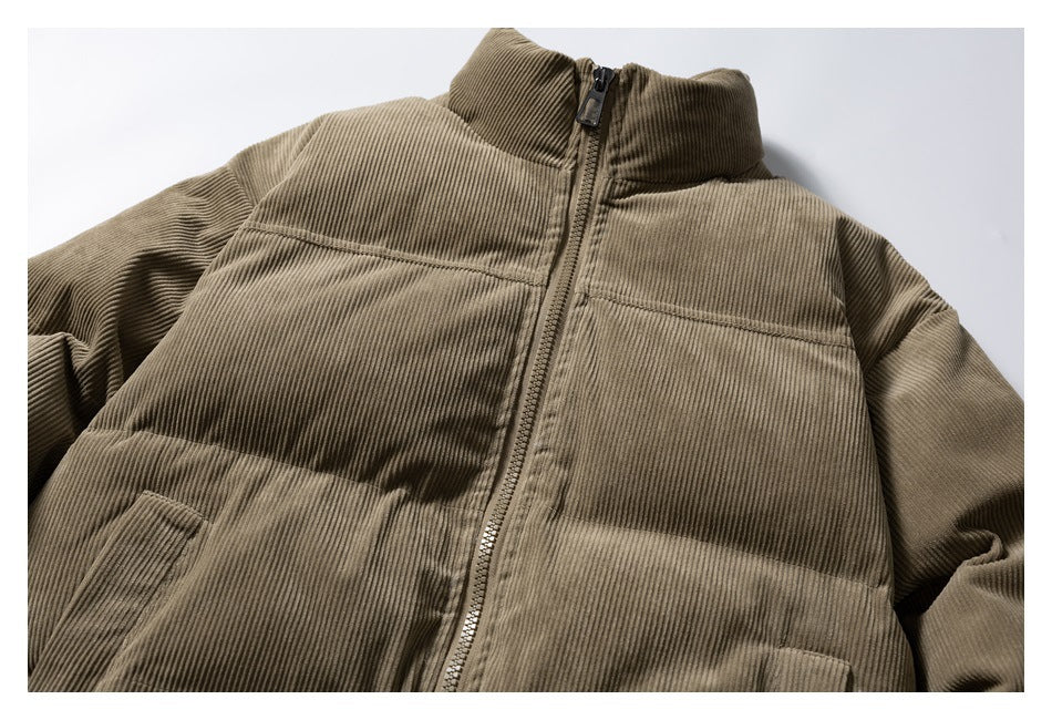 Close view of the olive-brown padded jacket front, showing its zipper, high collar, horizontal panels and pockets.